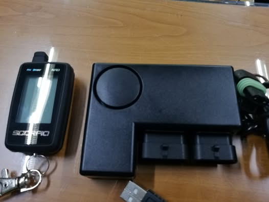 BMW GS1200 motorcycle alarm components laid out before installation